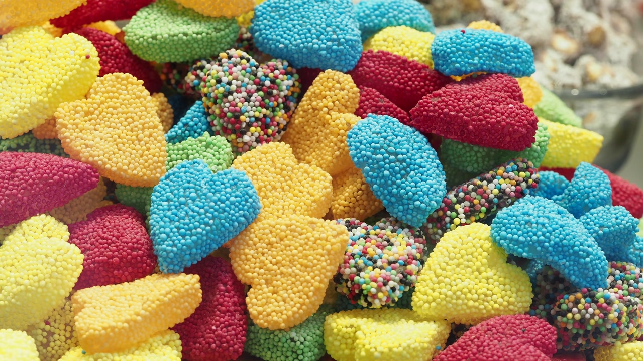 Vibrant Pile of Sweet Gummy Candies Covered in Sugar Sprinkles