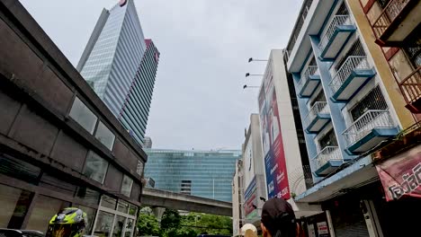 people walking near buildings and parked cars