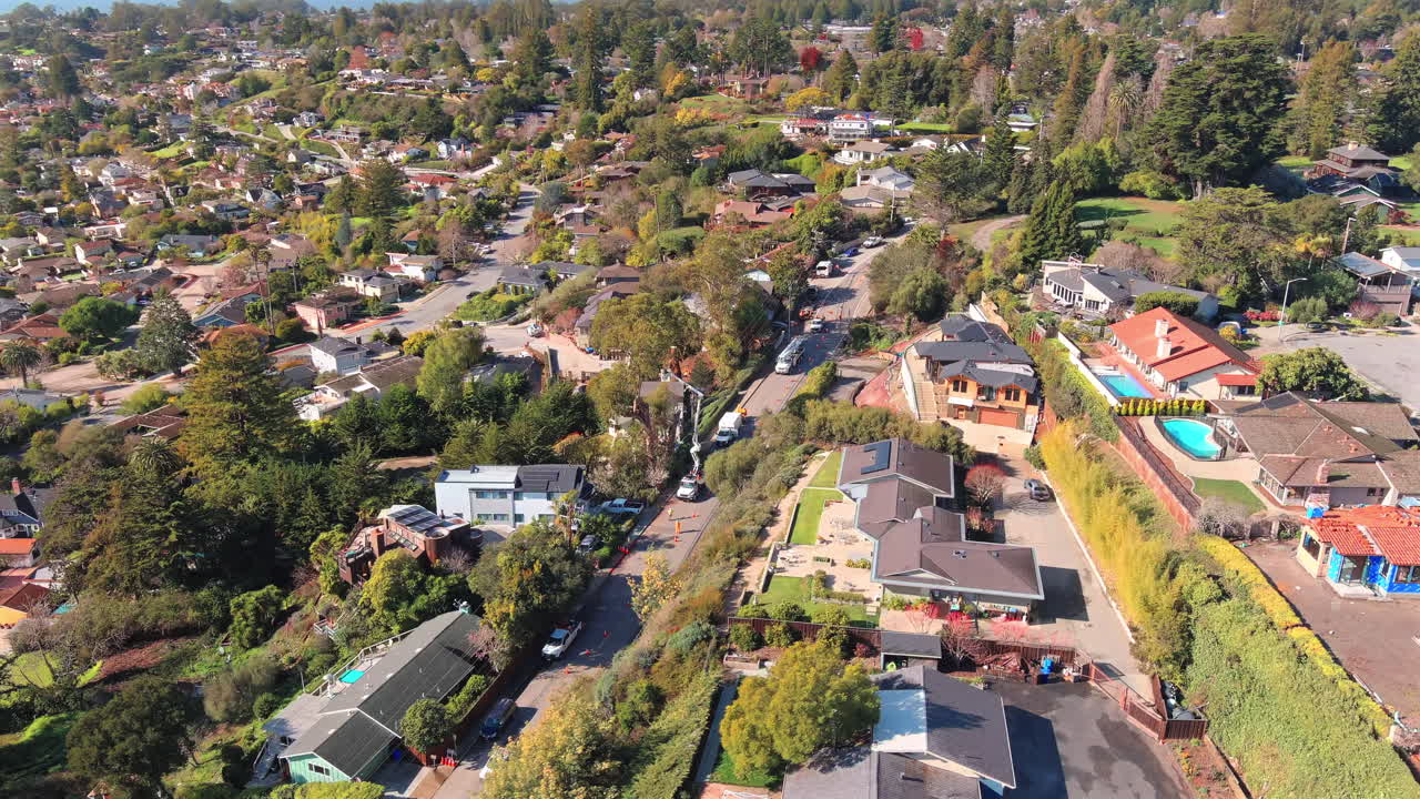 trabajo de mantenimiento de recorte de árboles con grúa en una calle residencial, vista aérea