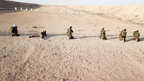 rows of first army soldiers practicing target shooting in the desert