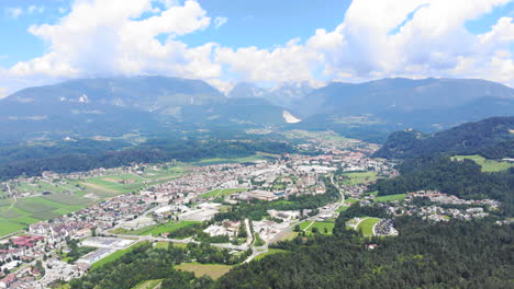 Extra-Wide-angle-Dolly-in-aerial-Shot-of-Volcji-Potok-Arboretum-and-the-surrounding-landscape-during-the-day