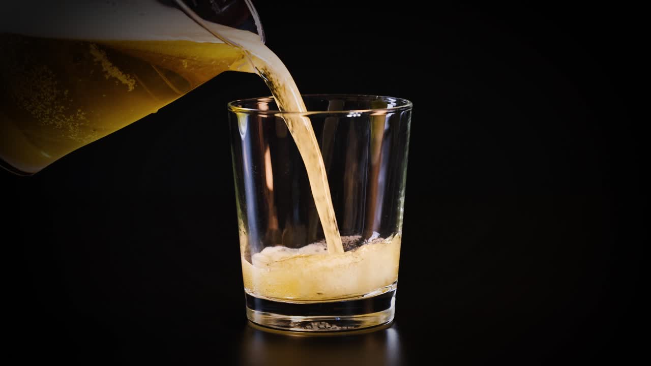 Beer being poured into a clear glass