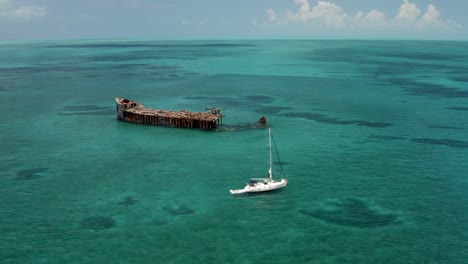 Motorboat-Sailing-Near-The-Wrecked-SS-Sapona-Cargo-Steamer-At-Port-Royal-In-Bahamas