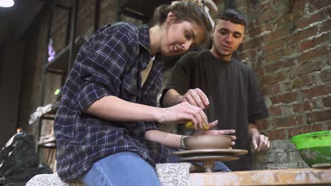 young people learning pottery