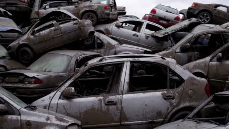 pile of damaged cars in a junkyard