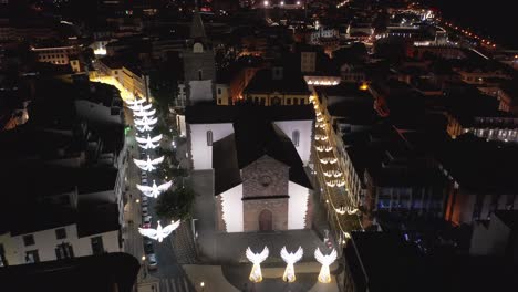 cathedral of funchal with white glowing angel decoration during christmas, aerial