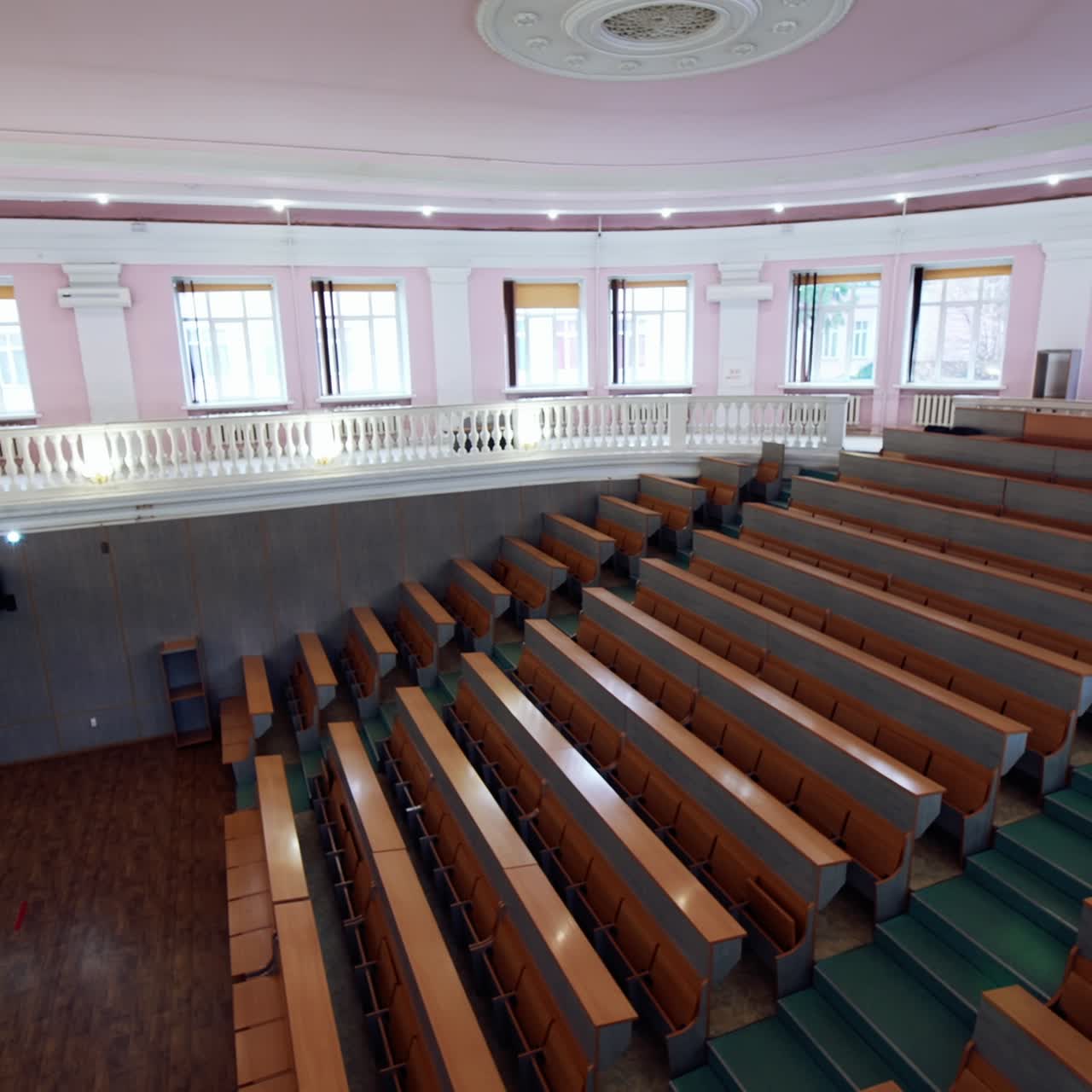 Large empty lecture hall. Modern auditorium with seats for students in the university. Light educational room with a white board in the centre