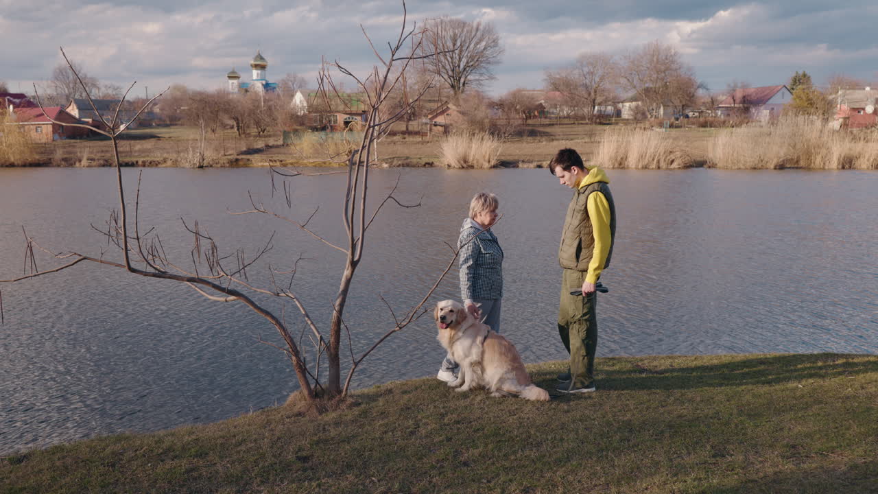 Couple with Dog by the River