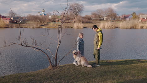 couple with dog by the river