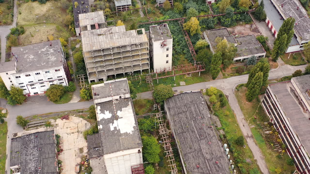 Old manufacture from above. Abandoned industrial territory with old buildings and warehouses. Empty factory. Orbital view.