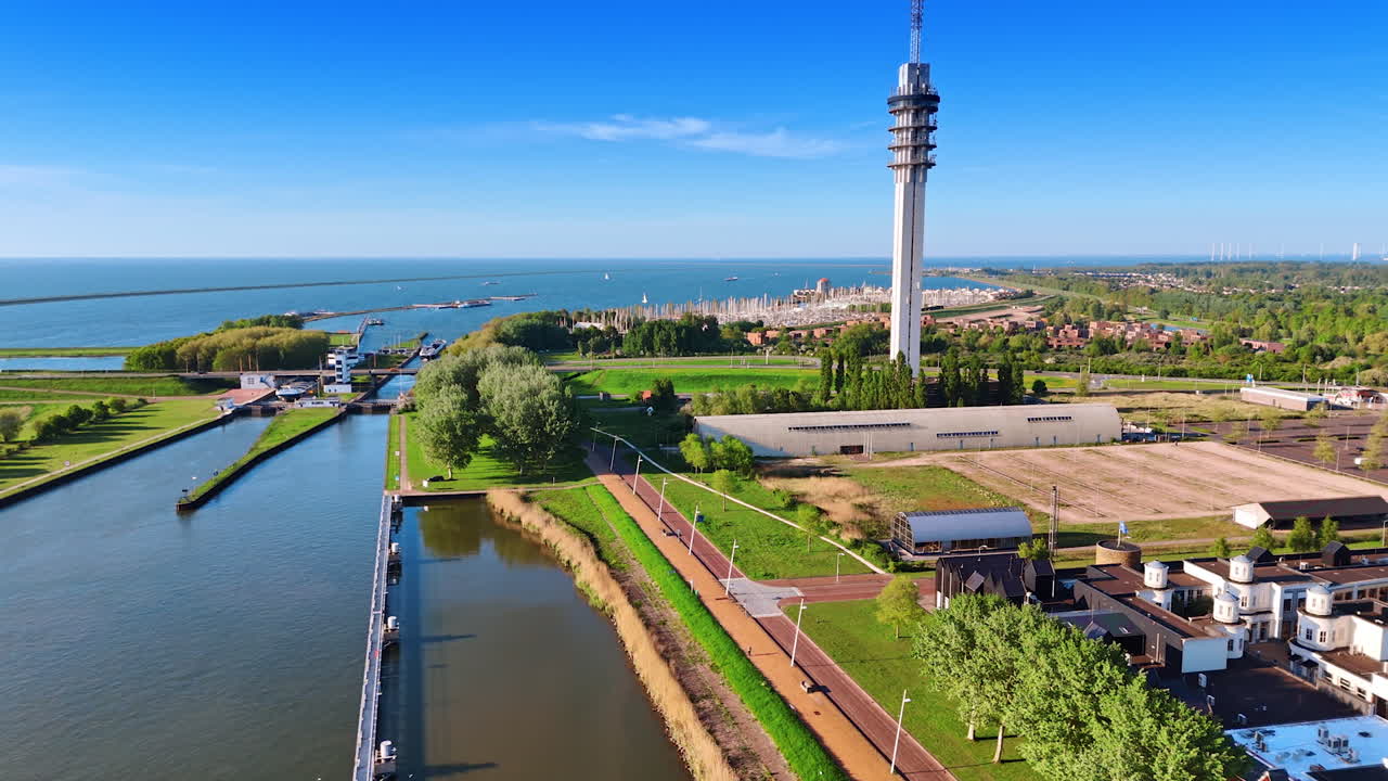 Lovely green waterfront of Lelystad, the Netherlands. Aerial perspective on telecom tower and yacht club at backdrop.