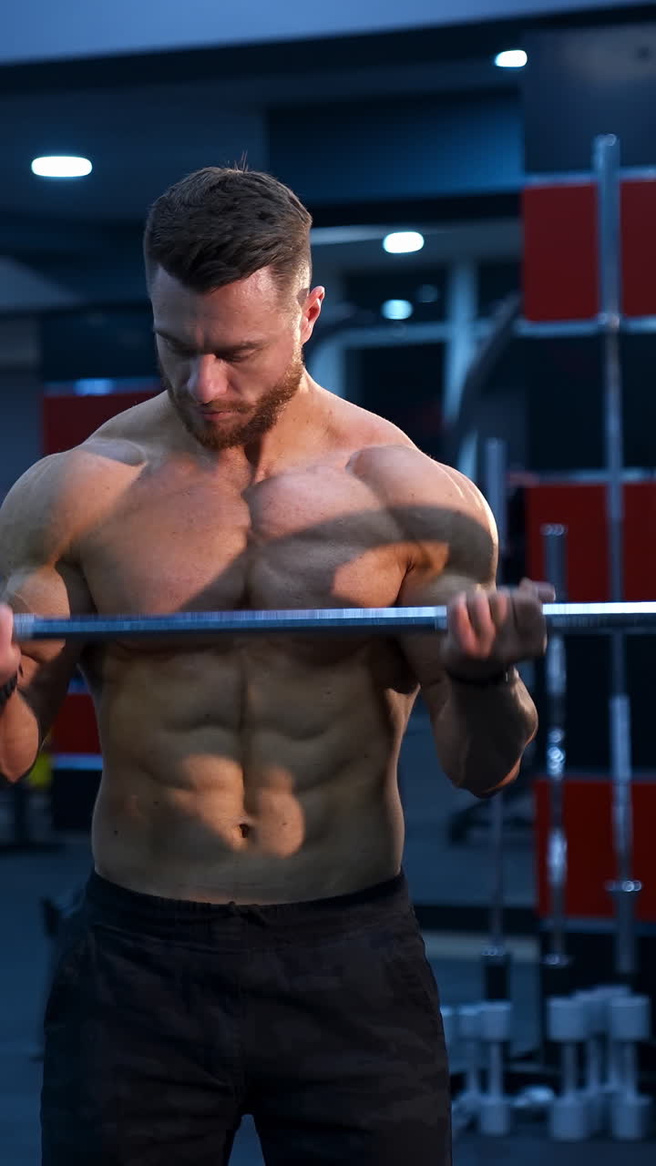 Young man doing fitness exercises. Fitness man doing exercises in the gym. Vertical video
