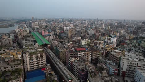 Aerial-view-of-the-Metro-Rail-trains-of-Dhaka-city,-docking-into-station