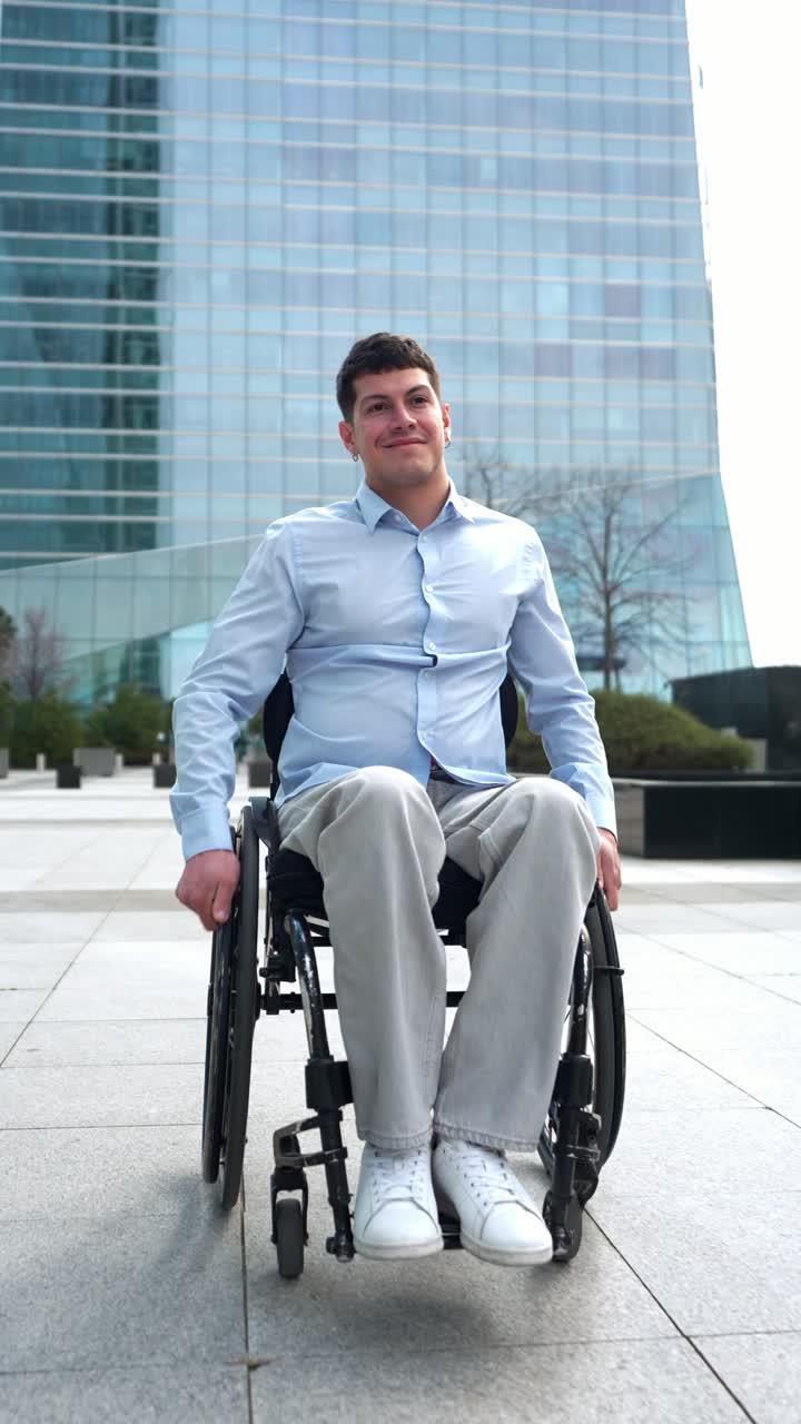 Smiling Young Man in Wheelchair in Front of Modern Building
