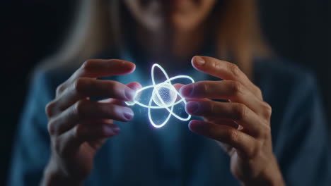 woman holding a glowing atom model