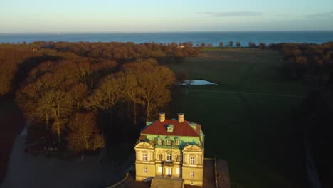 sun shining on iconic hunting lodge building, aerial drone view