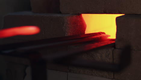 metal rods sit in a furnace inferno as the fire heats up