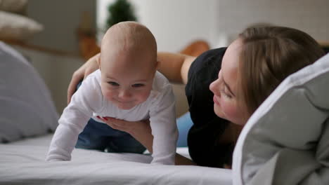 Portrait-of-happy-laughing-baby-hugging-with-cheerful-young-smiling-mother.-Scene-of-pure-love-and-happiness.-Family,-motherhood-and-lifestyle-concept.