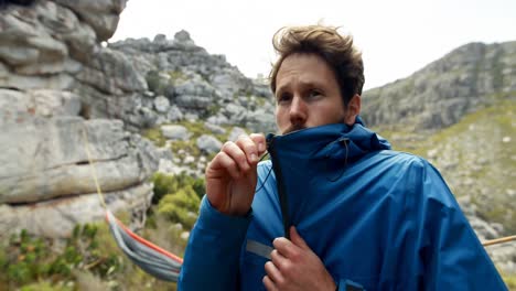 male hiker shivering from cold in countryside 4k