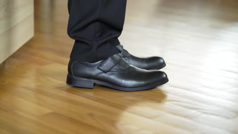barefoot guy put on ones shoes. close up of male legs putting shoes