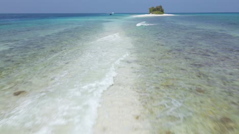 Low-flying-drone-shot-over-as-reef-in-the-maldives-tropical