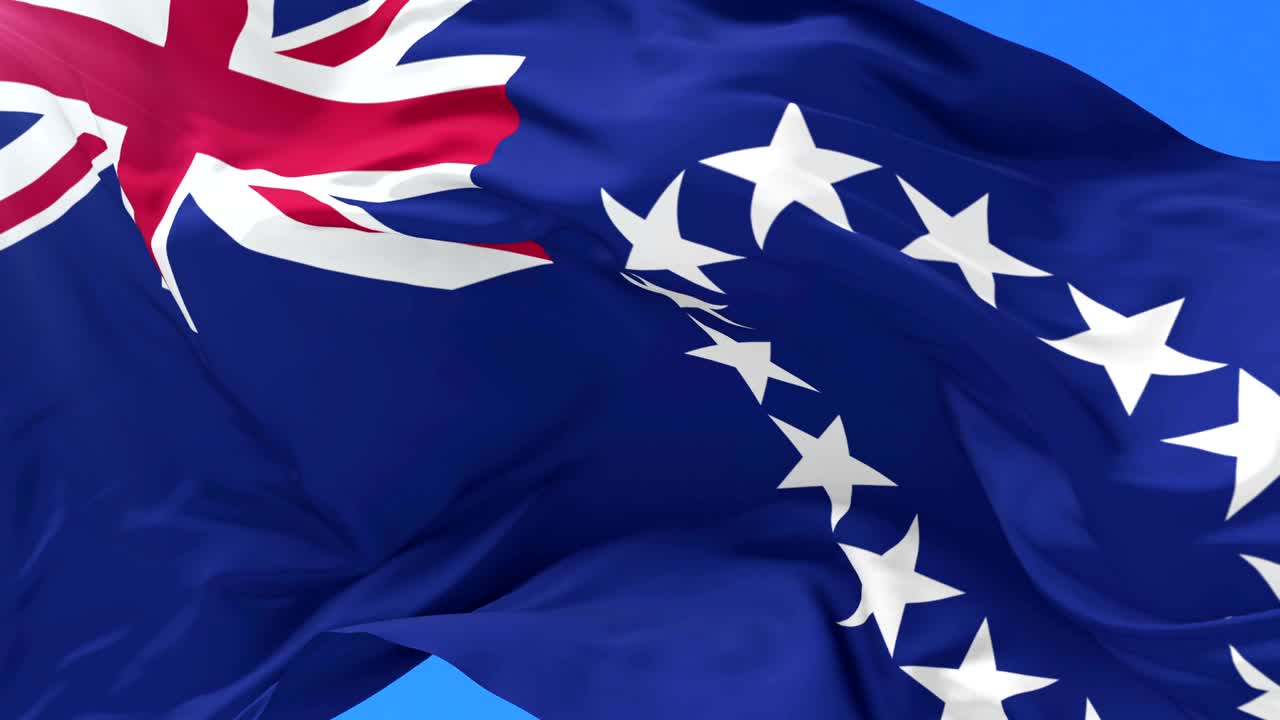 Flag of the Cook Islands waving at wind with blue sky in slow, loop