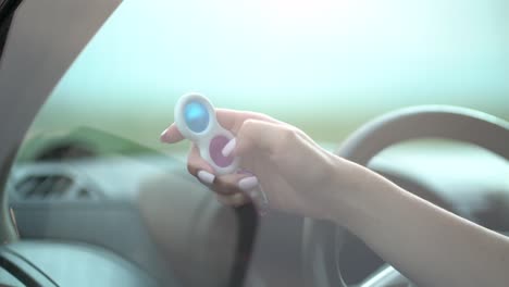 woman using pop it or simple dimple in car.