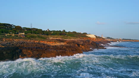 ocean waves splashing coast aerial view. picturesque rocky sea with asphalt road