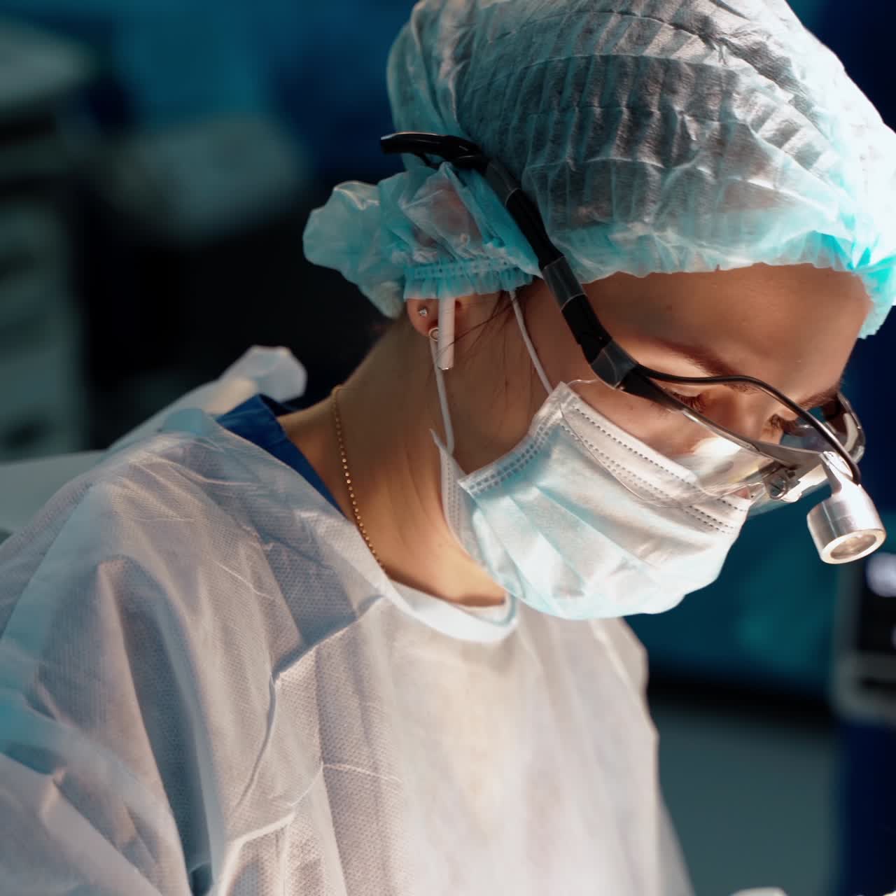 Doctor works with medical equipment. Female specialist with magnifying glass on head doing a plastic surgery to a patient.