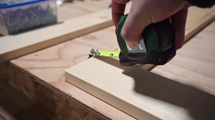 Tape Measure Used In Measuring Length Of A Wooden Frame
