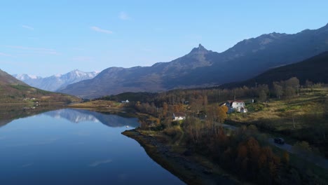 Aerial-of-car-driving-along-small-scenic-road-in-northern-norway