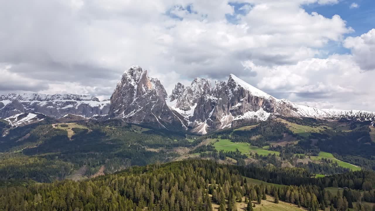 Drone hyperlapse of Dolomites mountains in Alpe di Siusi with Sassolungo peak and moving clouds