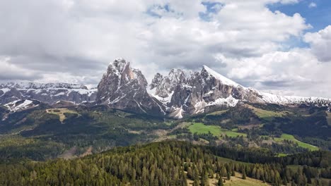 drone hyperlapse of dolomites mountains in alpe di siusi with sassolungo peak and moving clouds