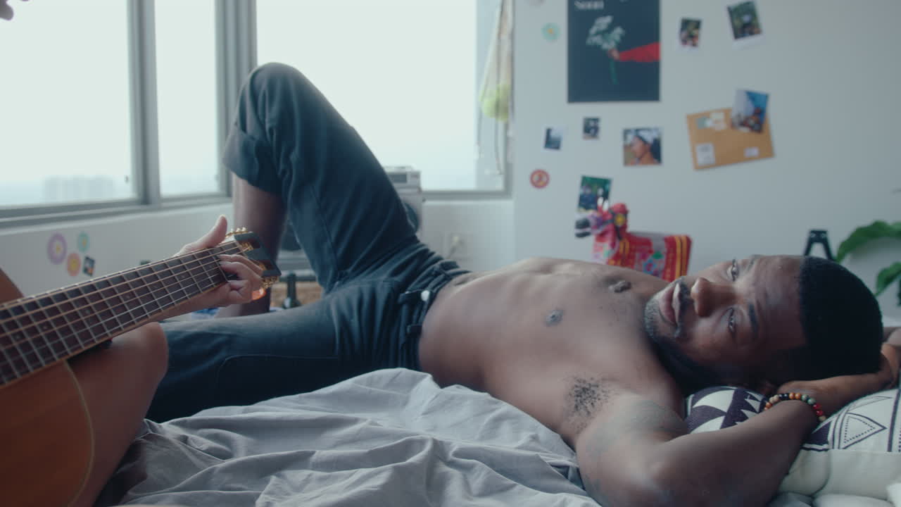 Woman Singing to Guitar For Her Boyfriend in Bedroom