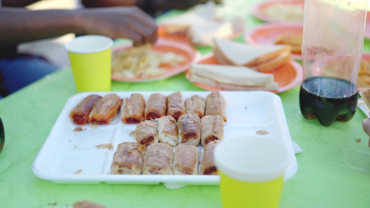 A table laden with snacks and drinks at a casual gathering