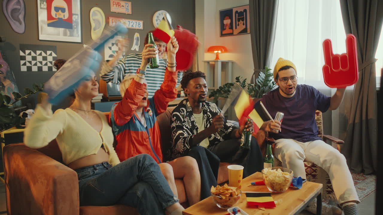 Excited Friends Cheering for Favorite Team with Belgium Flags in Living Room