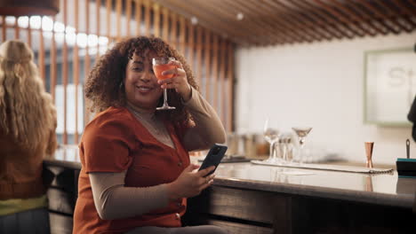 woman enjoying a cocktail at a bar