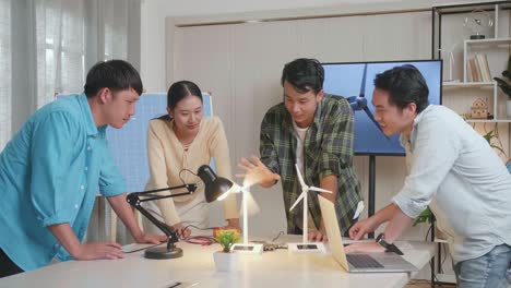 asian engineers group testing the wind turbine while having a meeting at the office