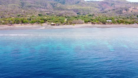 Aerial-drone-flying-over-deep-blue-ocean-and