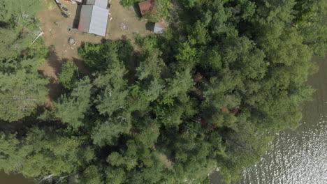 Aerial-top-down-shot-of-a-small-private-island-with-a-cottage