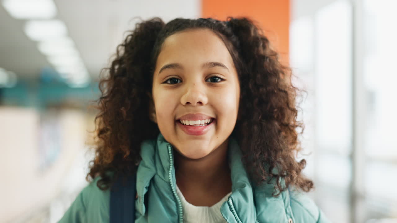 Portrait of a smiling girl in a school hallway