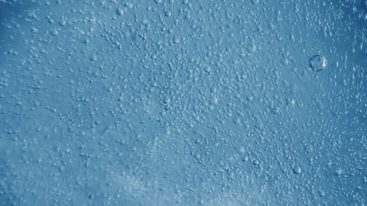 Oxygen bubbles in water on a blue abstract background