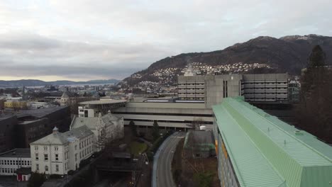 Haukeland-university-hospital-in-city-of-Bergen-Norway---Upward-moving-aerial-with-tilt-down-over-hospital-buildings