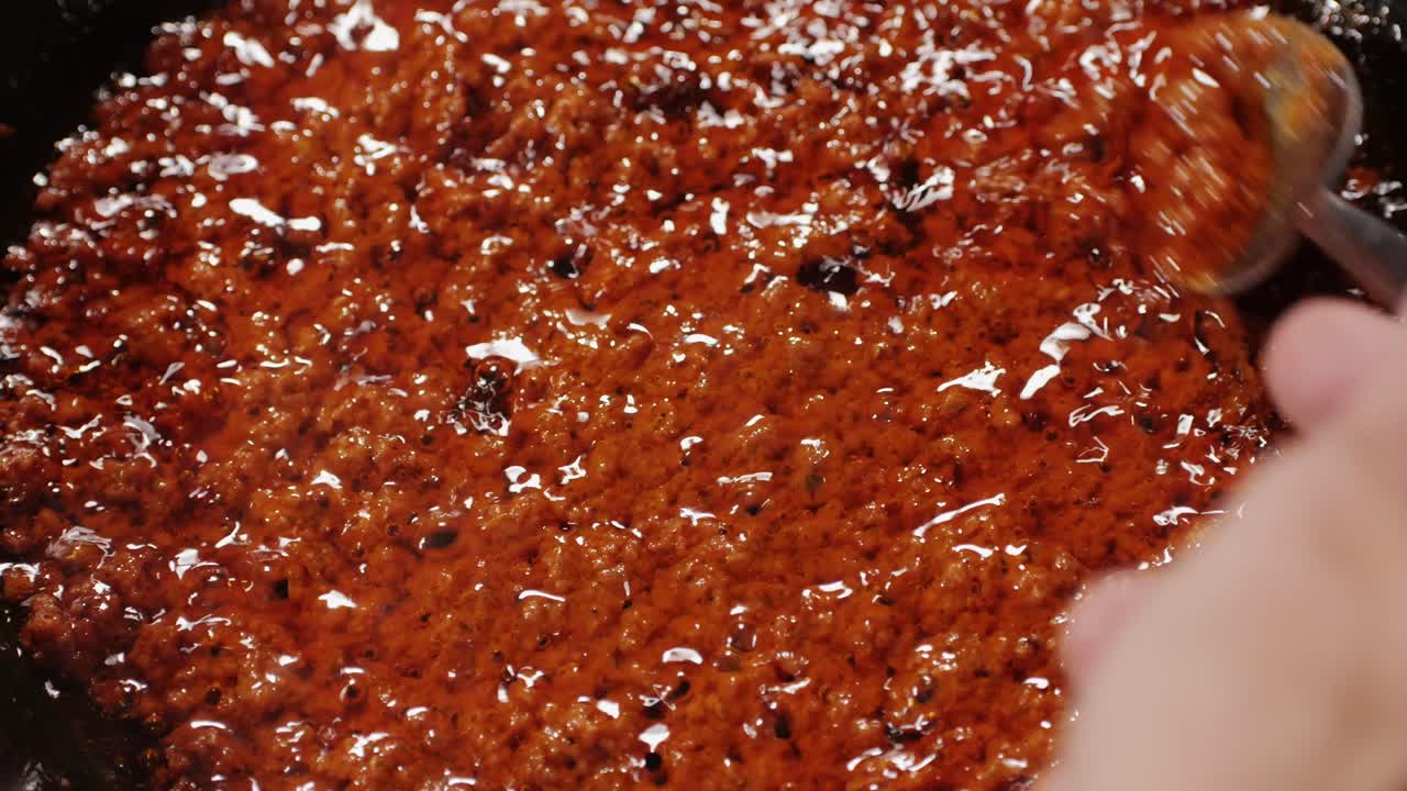 Cooking tomato sauce top view. Classic homemade Italian tomato sauce for pasta and pizza in the pan. Chef cooking traditional Italian food. High quality 4k footage