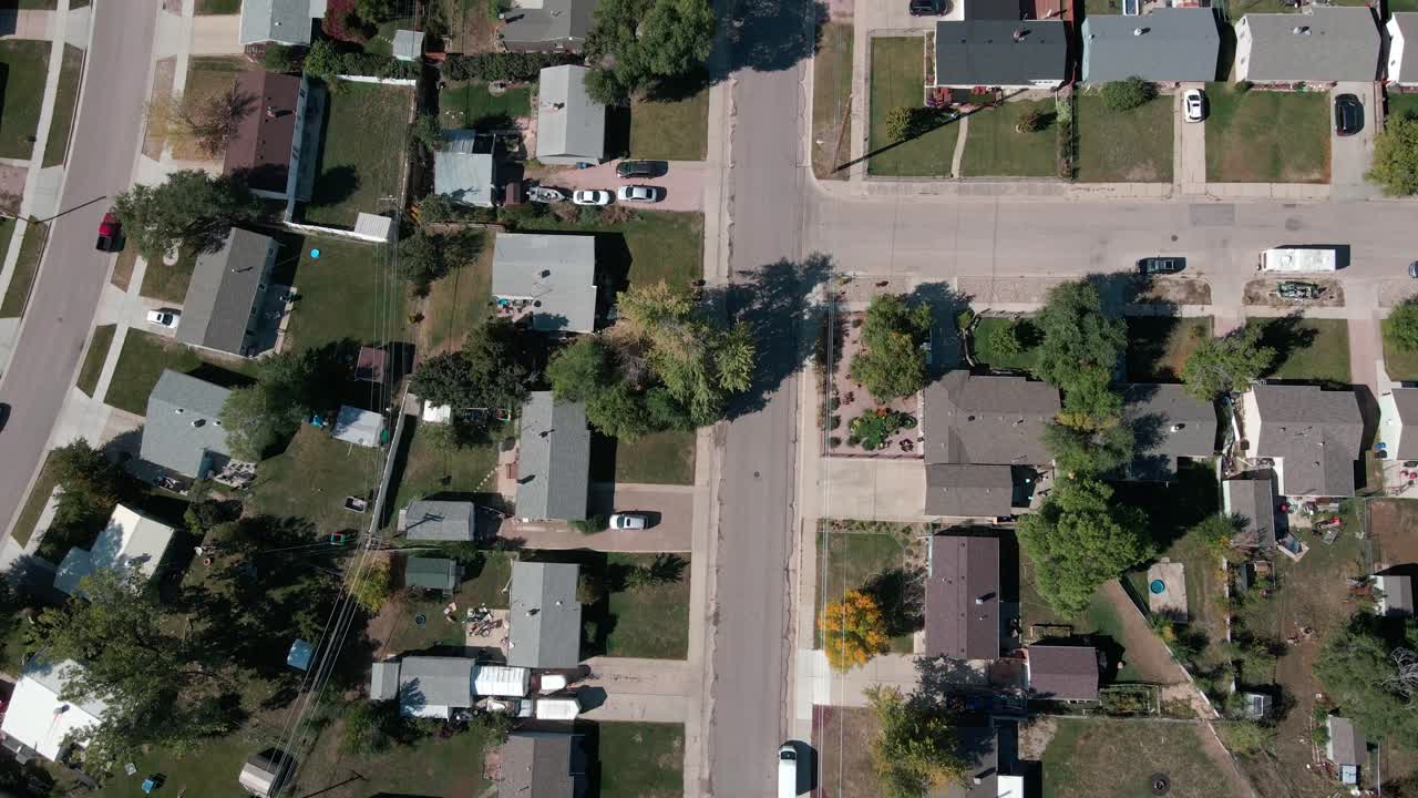 A drone shot flying over a street in a residential area