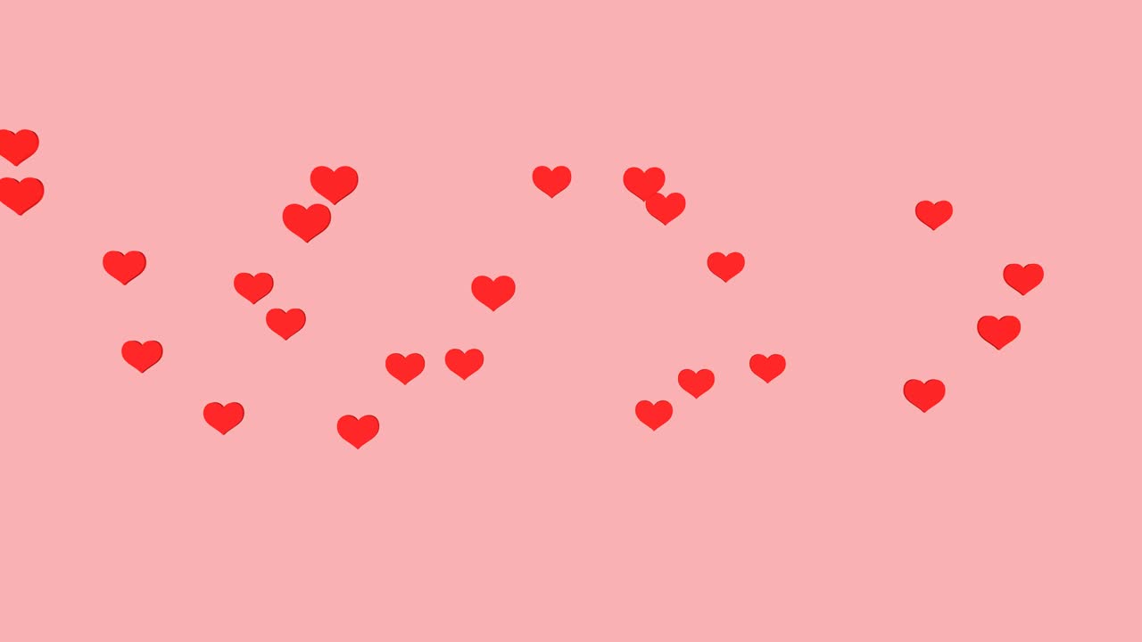 Il movimento di piccoli cuori rossi su uno sfondo rosa.