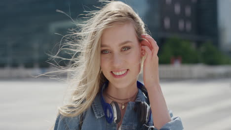 portrait-beautiful-young-blonde-woman-smiling-running-hand-through-hair-enjoying-relaxed-urban-day-in-city-slow-motion-feminine-beauty