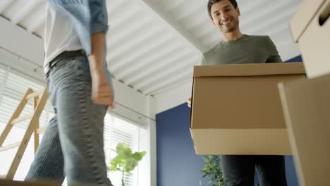 Video of couple going with cardboard boxes while moving house.