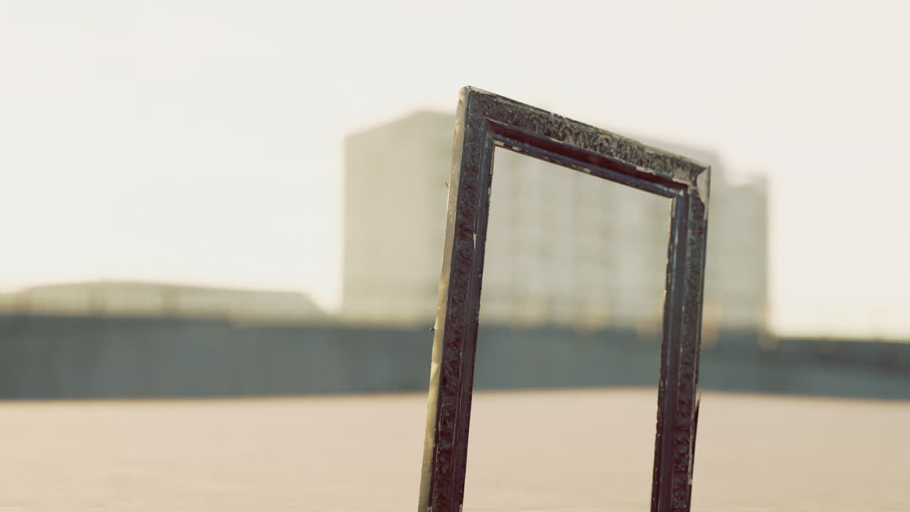 Unique empty frame standing in a vast outdoor space under clear sky