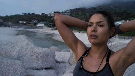 tired, running and fitness woman at a beach